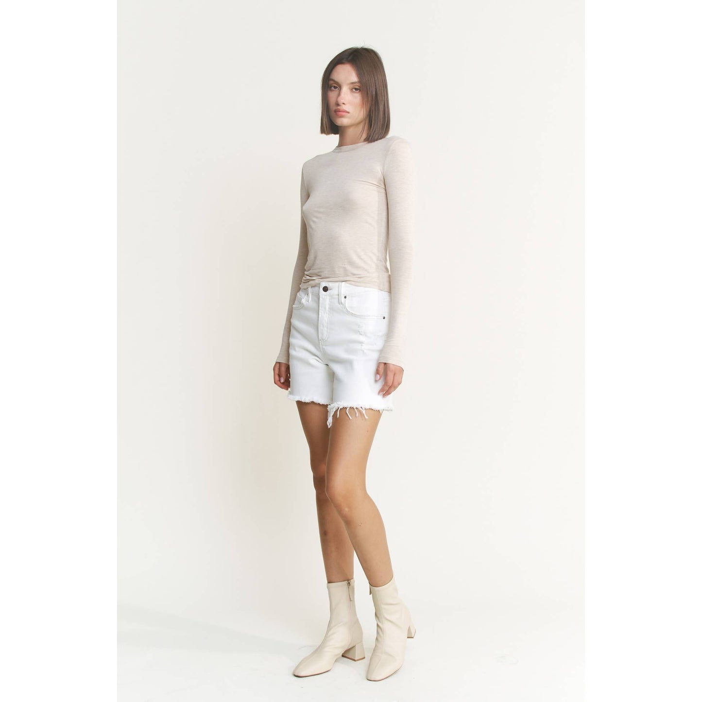 Distressed High Rise Frayed Denim Shorts in Misty White